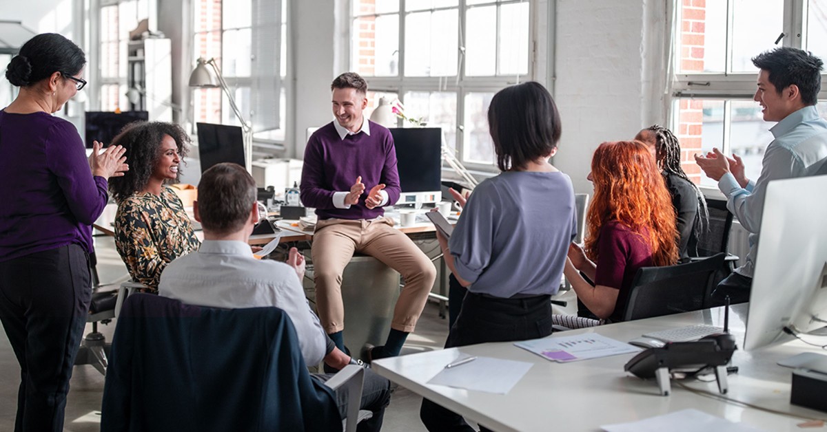 Group of learners gathered around an instructor during a class